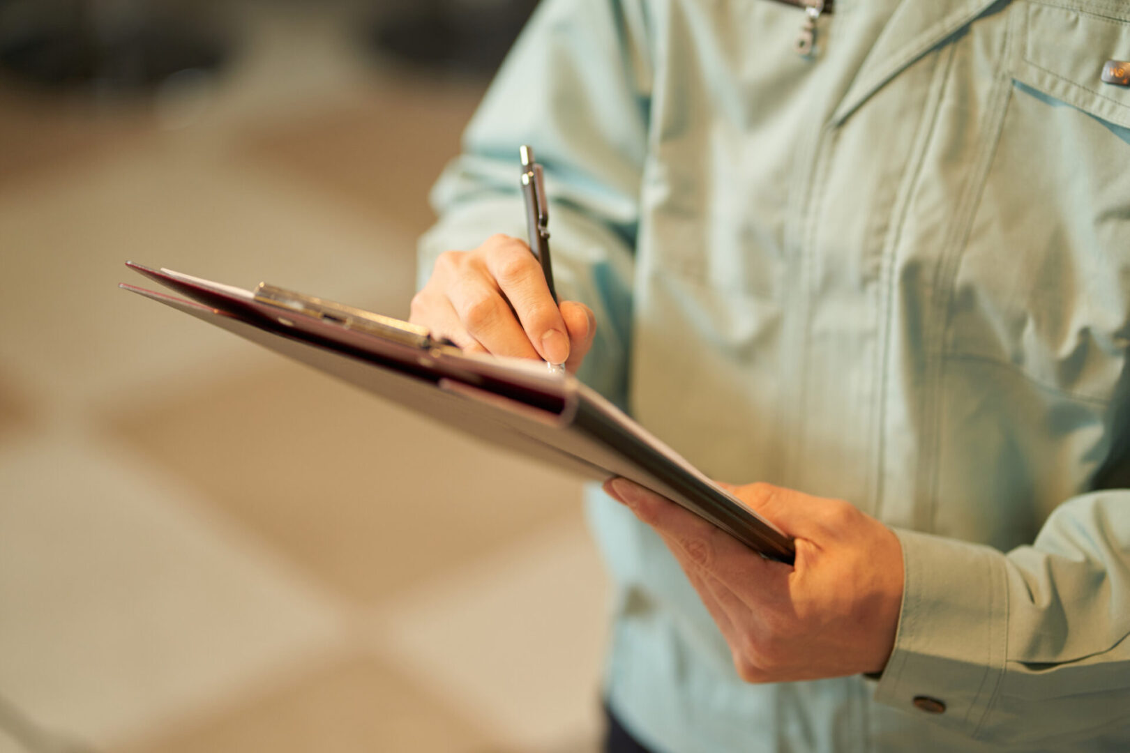 Worker taking notes on clipboard