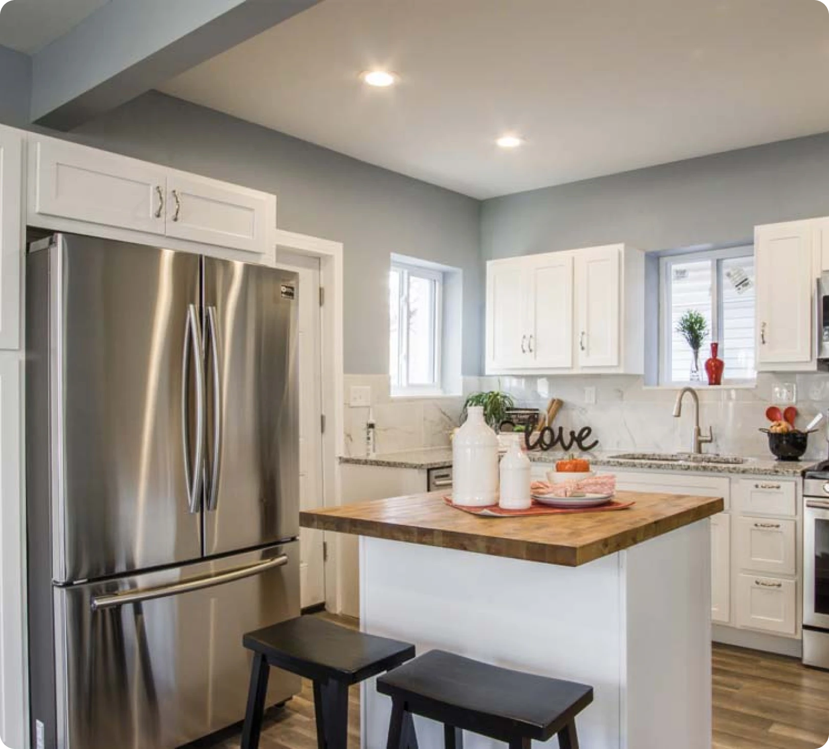 Bright kitchen featuring white cabinets