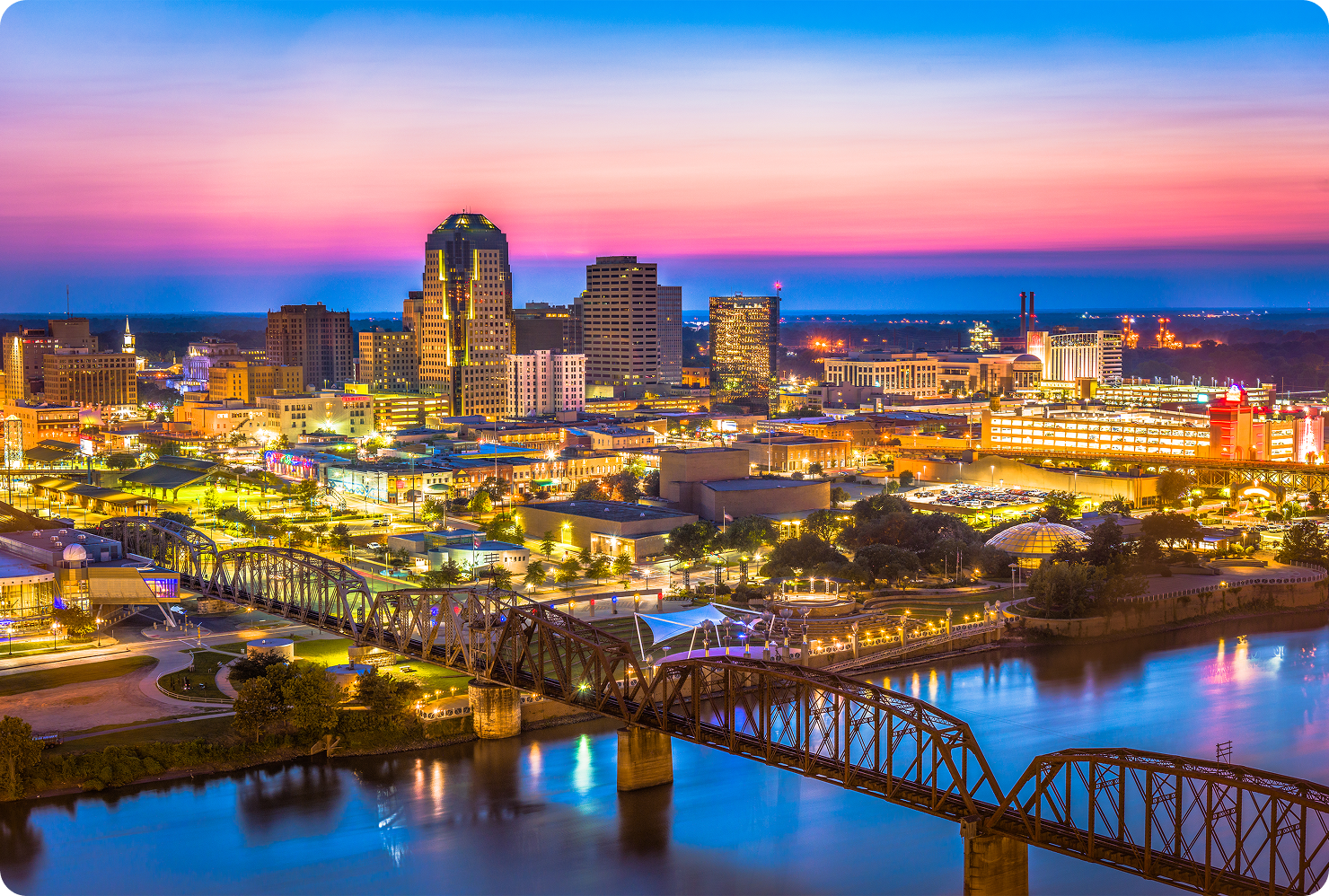 City skyline at sunset with vibrant lights