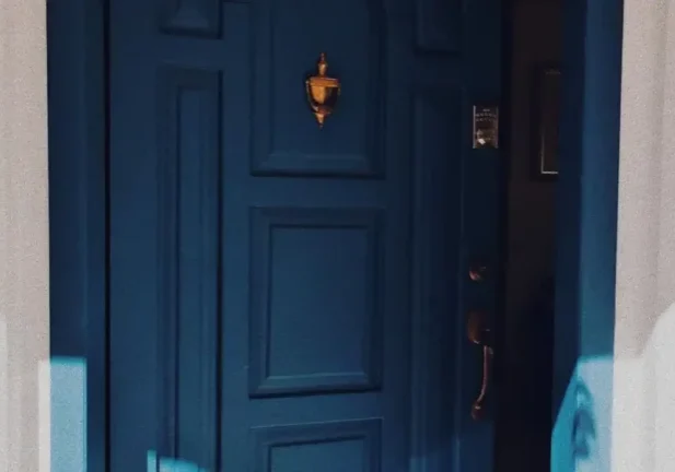 Stylish blue door with shadows
